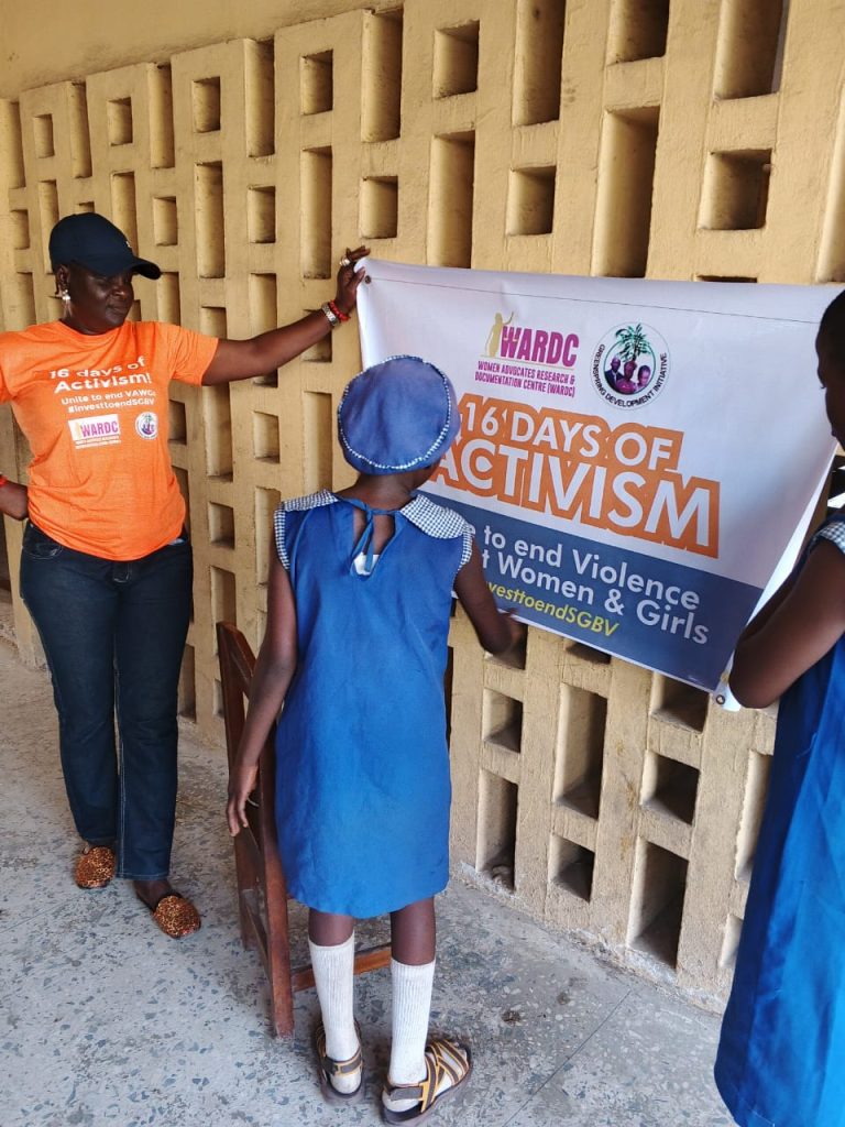 A primary school pupil reading the content of the sensitization banner.